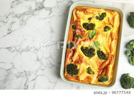 Tasty broccoli casserole in baking dish on white marble table, flat lay. Space for text 96777548