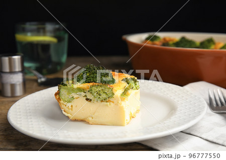 Tasty broccoli casserole served on wooden table, closeup 96777550