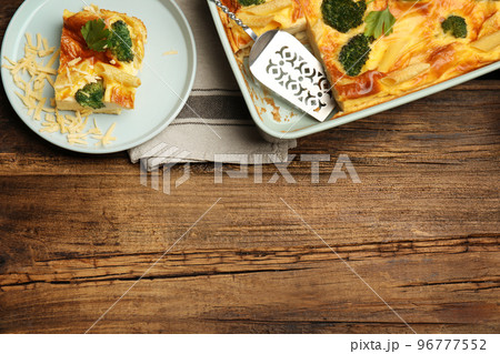 Tasty broccoli casserole served on wooden table, flat lay. Space for text Tasty broccoli casserole served on wooden table, flat lay. Space for text 96777552
