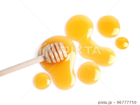 Drops of honey and dipper on white background, top view Drops of honey and dipper on white background, top view 96777750