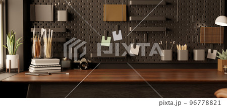 Modern black home office space with accessories and copy space on wood table against the black wall Modern black home office space with accessories and copy space on wood table against the black wall 96778821