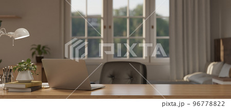 Comfortable and minimal working table in bedroom with laptop and copy space on wood table Comfortable and minimal working table in bedroom with laptop and copy space on wood table 96778822
