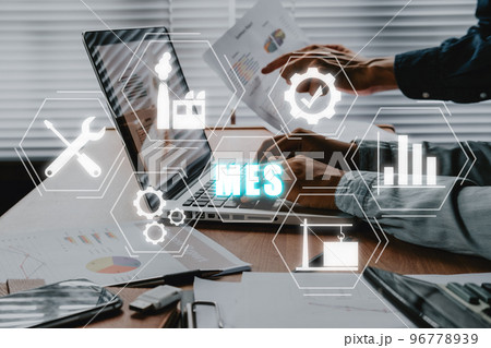 MES - Manufacturing Execution System concept, Business adviser meeting to analyze and discuss the situation on the financial report with mes icon on virtual screen. 96778939