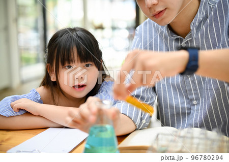 Cute young Asian girl is excited and enjoying doing a science experiment with her teacher Cute young Asian girl is excited and enjoying doing a science experiment with her teacher 96780294