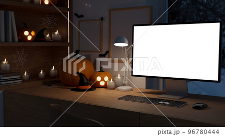 Dark working space in Halloween theme decor with white desktop computer mockup 96780444