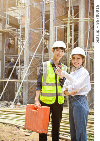 Handsome Asian male civil engineer and female architect in the construction site. 96780916