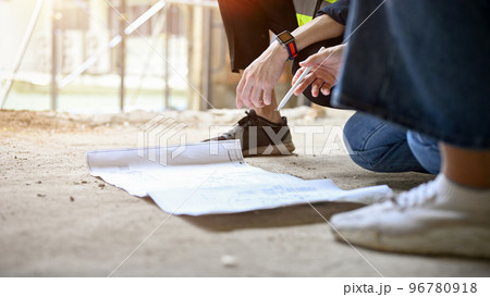 A blueprint is on the ground in the construction site. close-up image 96780918