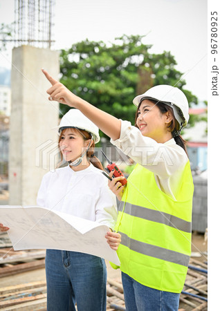 Beautiful Asian female engineer and female architect at the construction site. 96780925