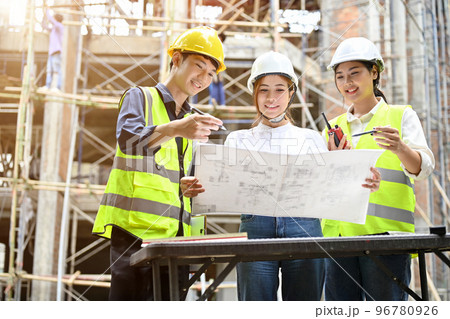 A team of professional asian engineer working together at the construction site. 96780926