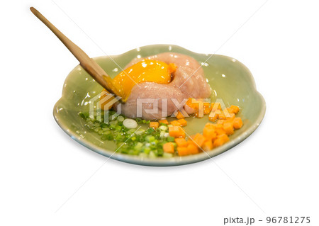 Top view of Fresh eggs on minced pork with preparation in the green bowl, focus selective Top view of Fresh eggs on minced pork with preparation in the green bowl, focus selective 96781275