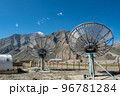 Communication satellite dishes network technology in rural area with the range of mountain and blue sky background. 96781284