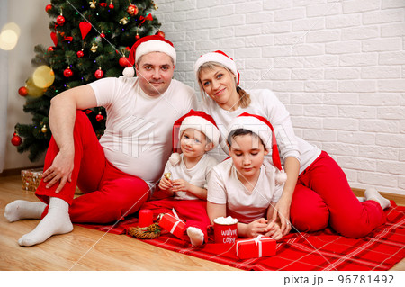 Christmas family and fir tree with gift boxes. Christmas family time. 96781492