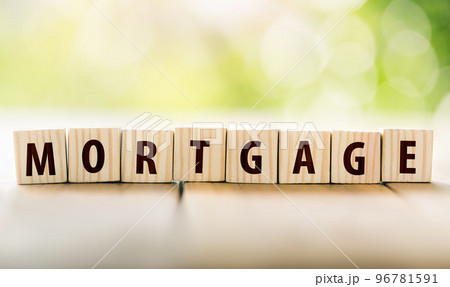 Wooden blocks arranged to form the word mortgage. planning savings a home concept for property, mortgage and real estate investment for a house. Wooden blocks arranged to form the word mortgage. planning savings a home concept for property, mortgage and real estate investment for a house. 96781591