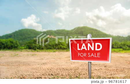 land for sale sign against trimmed lawn background. Empty dry cracked swamp reclamation soil. land for sale sign against trimmed lawn background. Empty dry cracked swamp reclamation soil. 96781617