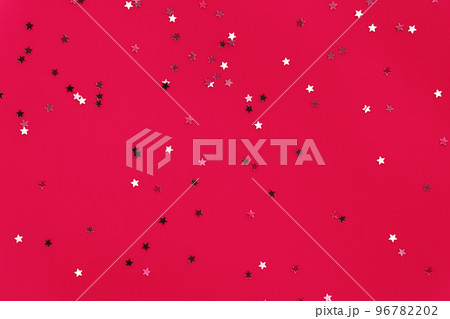 Silver stars glittering confetti on festive pink background. Trendy festive holiday backdrop. Many star-shaped particles for a postcard, invintation or web banner. 2023 Xmas celebration concept Silver stars glittering confetti on festive pink background. Trendy festive holiday backdrop. Many star-shaped particles for a postcard, invintation or web banner. 2023 Xmas celebration concept 96782202