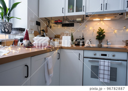 Food delivery service containers on table white scandi festive kitchen in christmas decor. Eve New year, saving time, too lazy to cook, hot order, disposable plastic box in fairy light. mock up 96782887