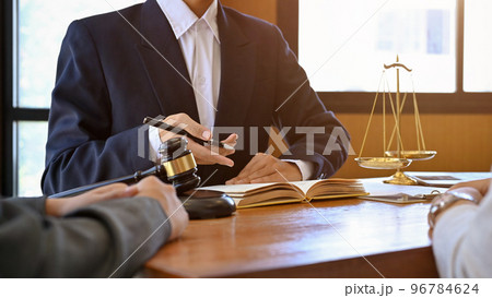 A professional male lawyer is giving advice and consulting on the lawsuit with his client A professional male lawyer is giving advice and consulting on the lawsuit with his client 96784624
