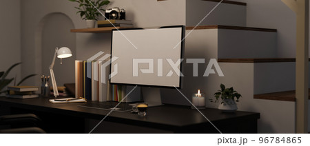 Modern home working space at night with computer mockup on black table near the stairs. Modern home working space at night with computer mockup on black table near the stairs. 96784865