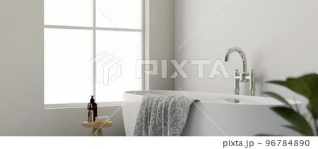 Modern elegance white bathroom interior with luxury bathtub, accessories, window and white wall 96784890