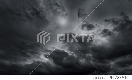 dark dramatic sky with black stormy clouds before rain or snow as abstract background, extreme weather, the sun shines through the clouds, high contrast photo dark dramatic sky with black stormy clouds before rain or snow as abstract background, extreme weather, the sun shines through the clouds, high contrast photo 96788910