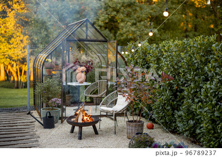 Beautiful garden with fireplace and glasshouse 96789237