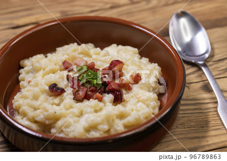 Slovakian halusky served with sheep cheese and roasted bacon 96789863