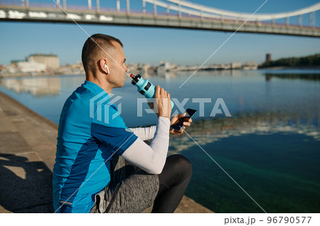 Athletic man rest after running functional workout outdoors 96790577