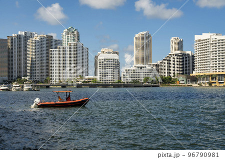 Orange boat on the ocean against the cityscape view at the bay in Miami, Florida 96790981