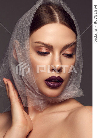 Modesty. Close-up portrait of glamorous female fashion model with artistic makeup expressing emotions over grey background. Style, beauty, high fashion, magazine style 96791894