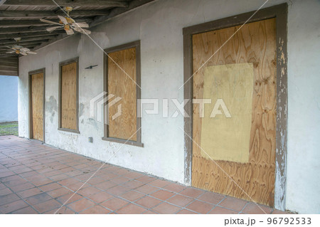 San Antonio, Texas- Exterior of an abandoned house with boarded doors and windows San Antonio, Texas- Exterior of an abandoned house with boarded doors and windows 96792533
