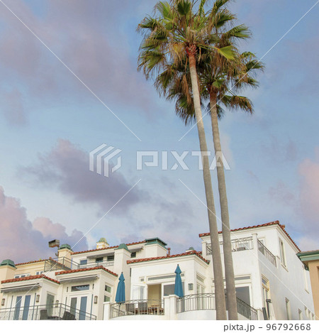 Square Puffy clouds at sunset Low angle view of mediterranean style building residences at La Square Puffy clouds at sunset Low angle view of mediterranean style building residences at La 96792668
