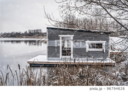 Floating grey cabin on the freezing lake Floating grey cabin on the freezing lake 96794626