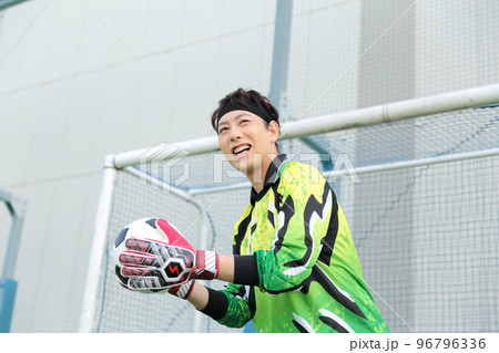 サッカーボールをキャッチするゴールキーパーの男性 96796336