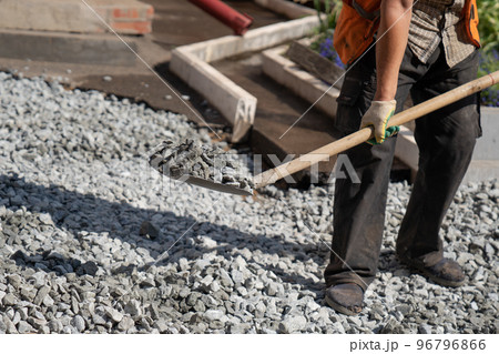 Male construction worker is loading gravel 96796866
