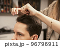 Barber shop men hairstyle. Young man getting a modern haircut. Hair salon master does hair styling 96796911