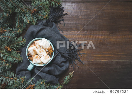 Christmas mug of hot coffee with marshmallow on wooden board. New Year. Holiday card. Rustic style. Top view and copy space. 96797524