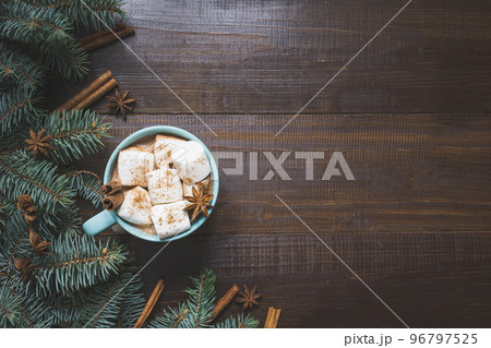 Christmas mug of hot coffee with marshmallow on wooden board. New Year. Holiday card. Rustic style. Top view and copy space. 96797525