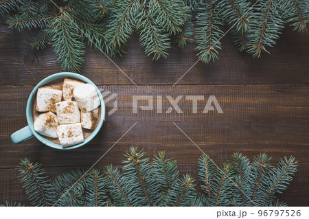Christmas mug of hot coffee with marshmallow on wooden board. New Year. Holiday card. Rustic style. Top view and copy space. 96797526