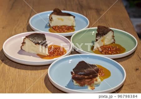 Piece of cheesecake with sea buckthorn jam on a plate 96798384