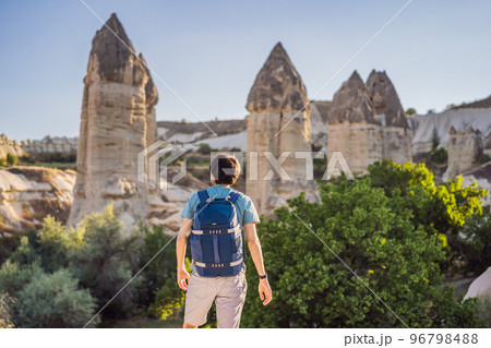 Man tourist on background of Unique geological formations in Love Valley in Cappadocia, popular travel destination in Turkey 96798488