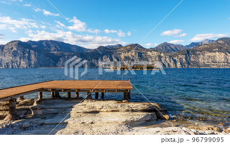 Beach and Wooden Pier of Lake Garda - Malcesine Village Veneto Italy 96799095