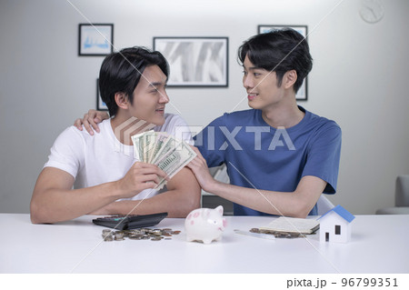 Asian gay couple saving money to buy a house 96799351