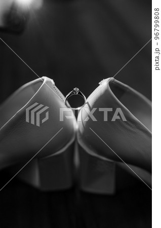 Ring with a stone on white women's leather shoes. Bride's accessories, bride's morning Ring with a stone on white women's leather shoes. Bride's accessories, bride's morning 96799808