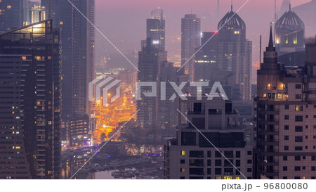 Dubai Marina and Media City districts with modern skyscrapers and office buildings aerial night to day timelapse. Dubai Marina and Media City districts with modern skyscrapers and office buildings aerial night to day timelapse. 96800080