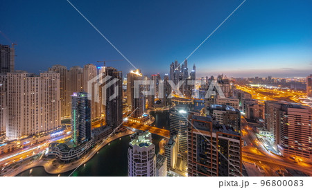 Panorama of various skyscrapers in tallest recidential block in Dubai Marina aerial night to day timelapse Panorama of various skyscrapers in tallest recidential block in Dubai Marina aerial night to day timelapse 96800083