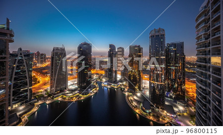 Tall residential buildings at JLT aerial night to day timelapse, part of the Dubai multi commodities centre mixed-use district. Tall residential buildings at JLT aerial night to day timelapse, part of the Dubai multi commodities centre mixed-use district. 96800115