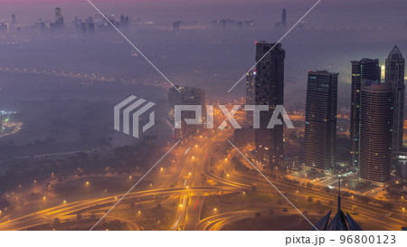 Big crossroad junction between JLT district and Dubai Marina intersected by Sheikh Zayed Road aerial night to day timelapse. 96800123