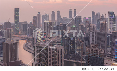 Skyline with modern architecture of Dubai business bay towers day to night timelapse. Aerial view Skyline with modern architecture of Dubai business bay towers day to night timelapse. Aerial view 96800334