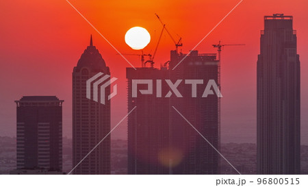 Skyline with modern architecture of Dubai business bay towers at sunset timelapse. Aerial view Skyline with modern architecture of Dubai business bay towers at sunset timelapse. Aerial view 96800515