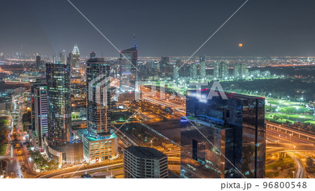 Moon rising over media city and al barsha heights district area night timelapse from Dubai marina. 96800548